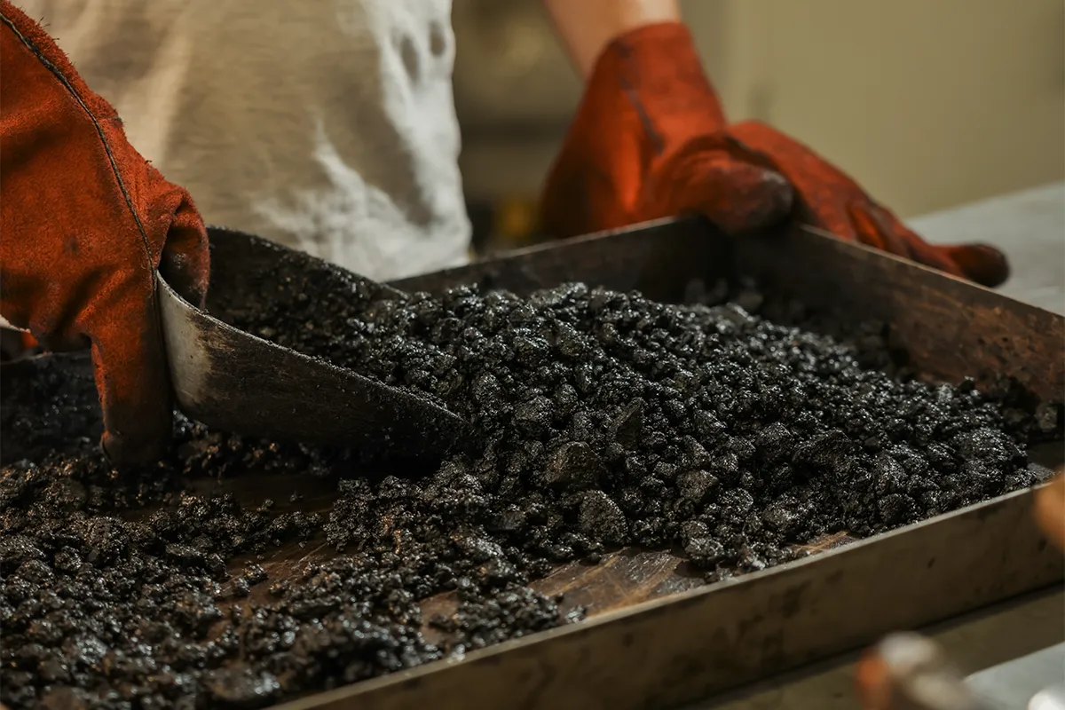 Tecnico Nuovolab manipola campione asfalto bituminoso laboratorio analisi